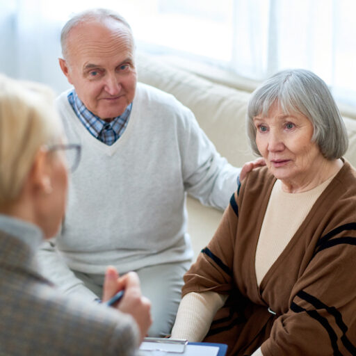 woman consulting with a senior couple about an assisted living community