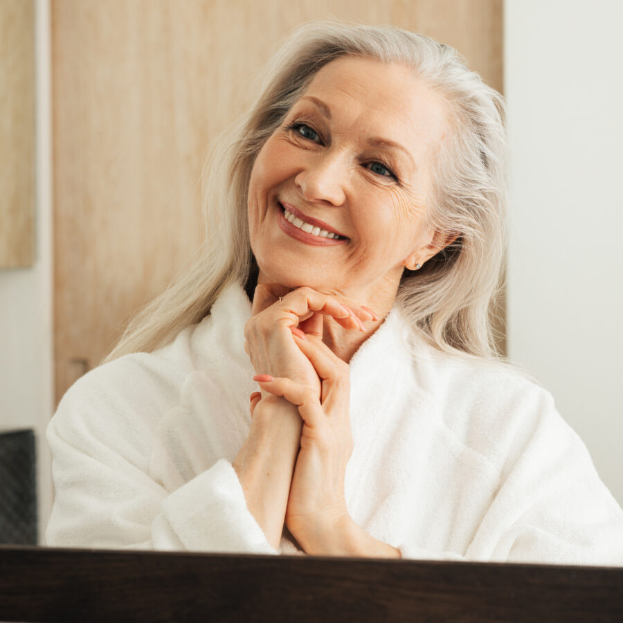 Senior woman looking in mirror | How to age with grace