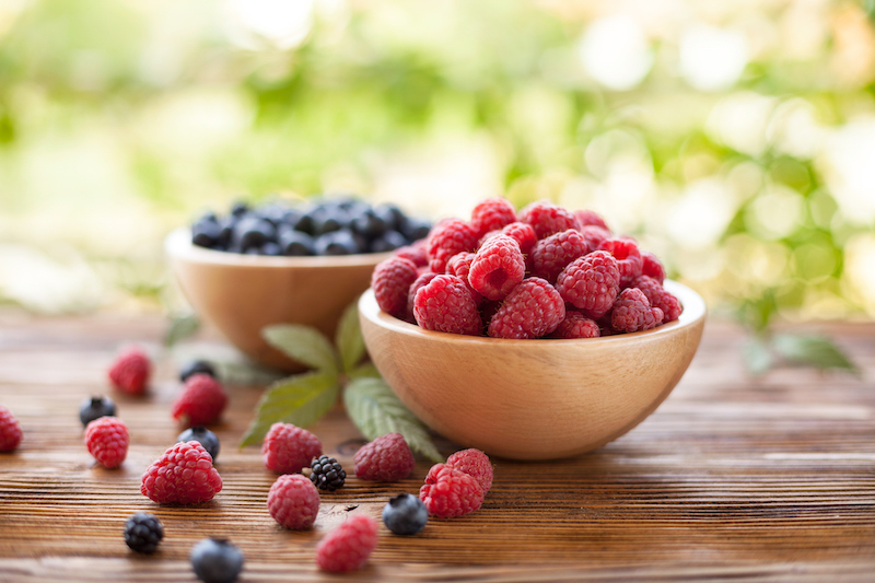 Fresh raspberries and blueberries which are foods for arthritis
