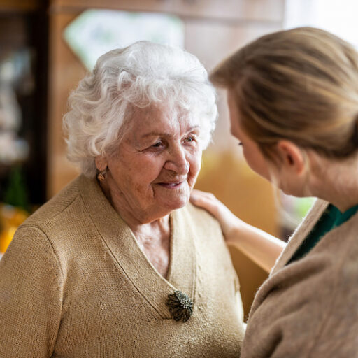 Caregiver talking to a senior women about person-centered care
