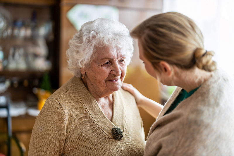 Caregiver talking to a senior women about person-centered care