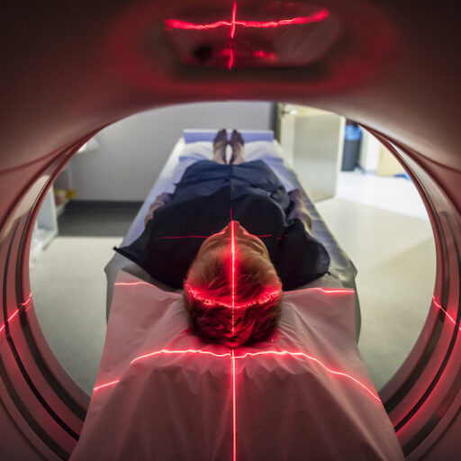 Patient lying inside a medical scanner in hospital getting a memory screening