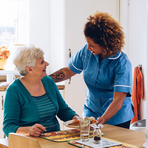 older woman talking to her in-home caregiver