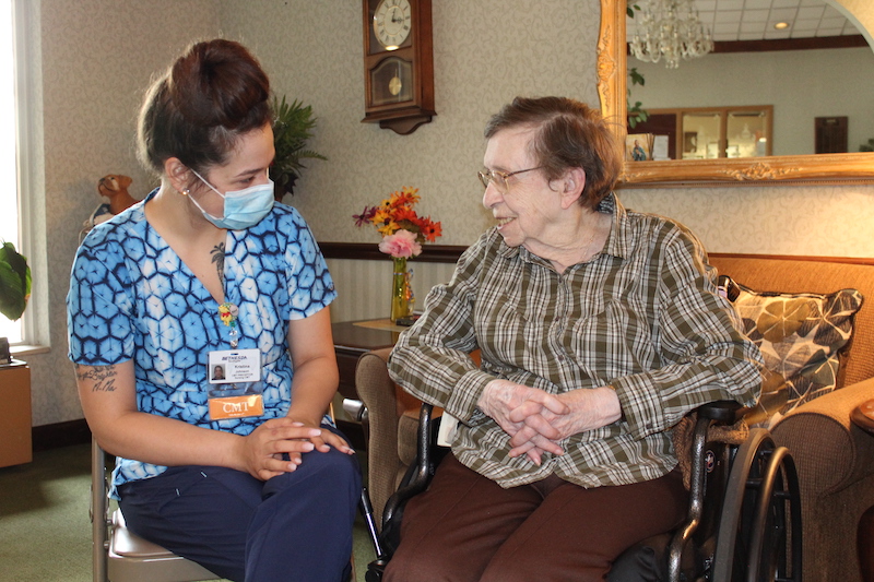 nurse working with elderly patient in healthcare careers