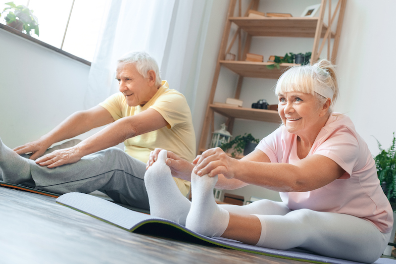 Senior couple doing yoga exercises for arthritis