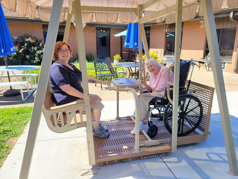 Southgate residents and loved ones enjoy the new Whisper Glider from the Women's Board