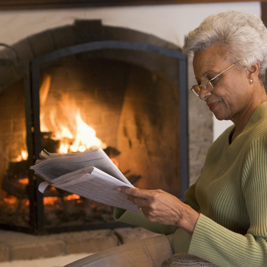 Woman by fireplace | Cold Weather Fire Hazards