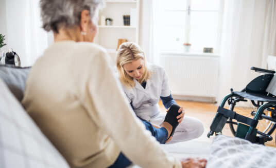 Caregiver Putting on Adaptive Clothing for Seniors