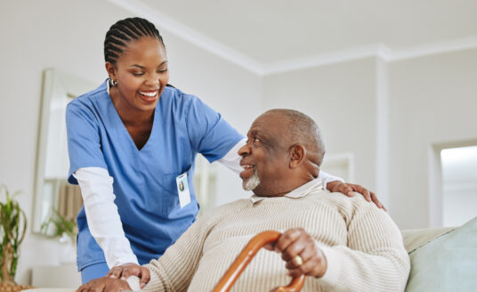 Caregiver talking to senior | At-Home Care for Seniors