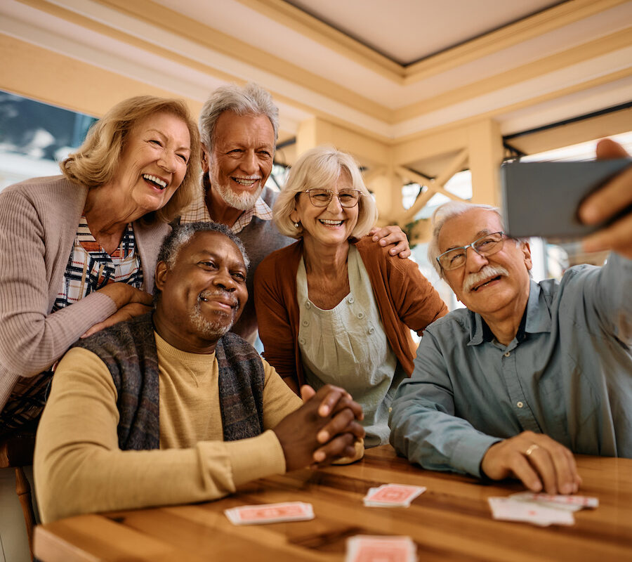 Cheerful senior have fun while taking selfie at retirement community of Senior Living apartments