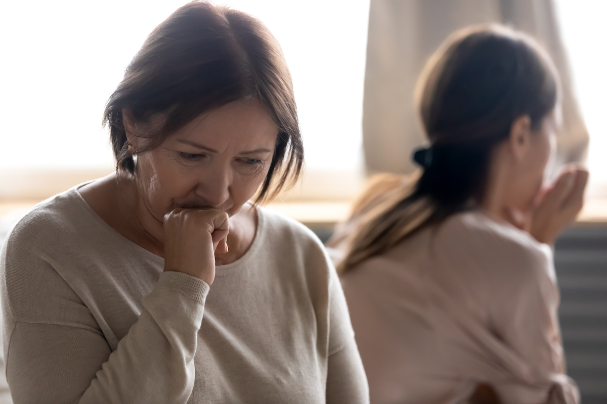 Sad senior mother involved in family quarrel with adult daughter who is caring for aging parents