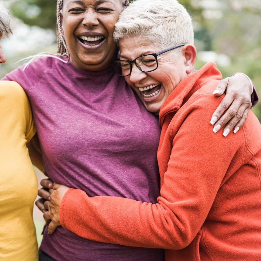 Senior women laughing with friends | Explore senior living solutions