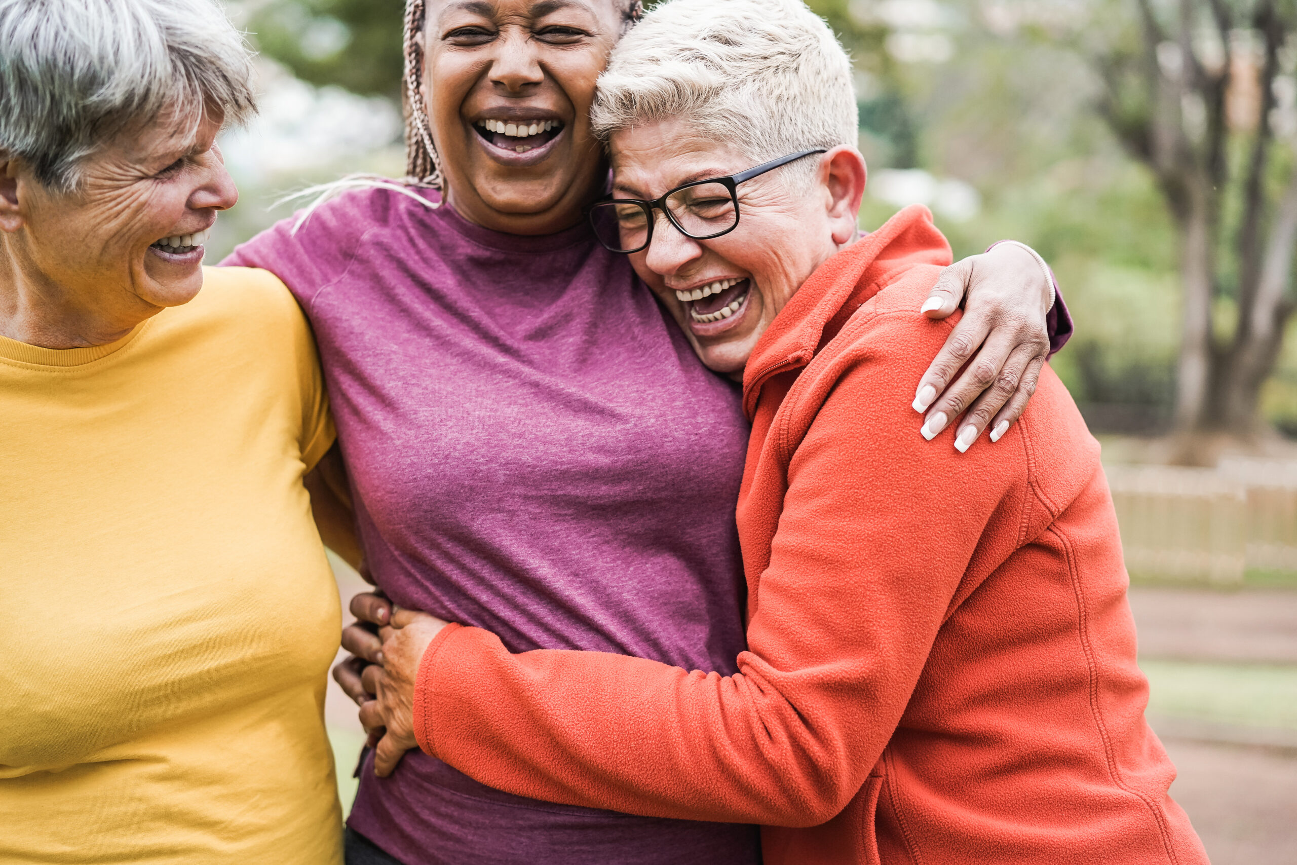 Senior women laughing with friends | Explore senior living solutions