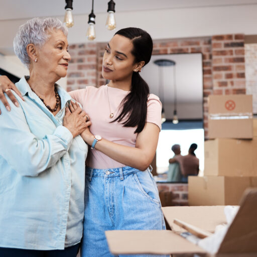Assisting senior woman with moving and utilizing senior moving checklist