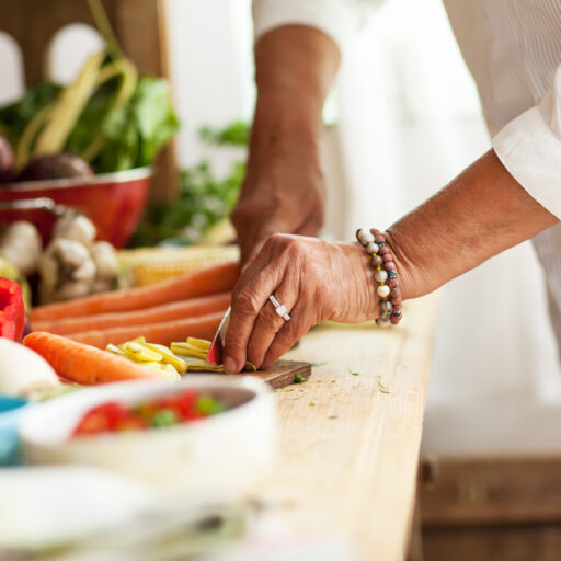 Senior woman preparing vegetables and healthy food