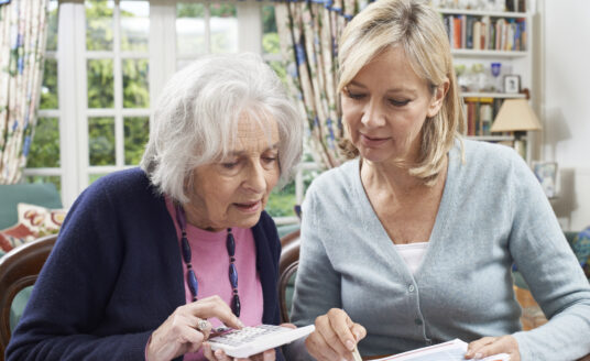 Mother and daughter partaking in financial planning for seniors