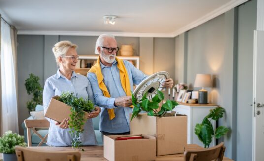 A senior couple unpack moving boxes