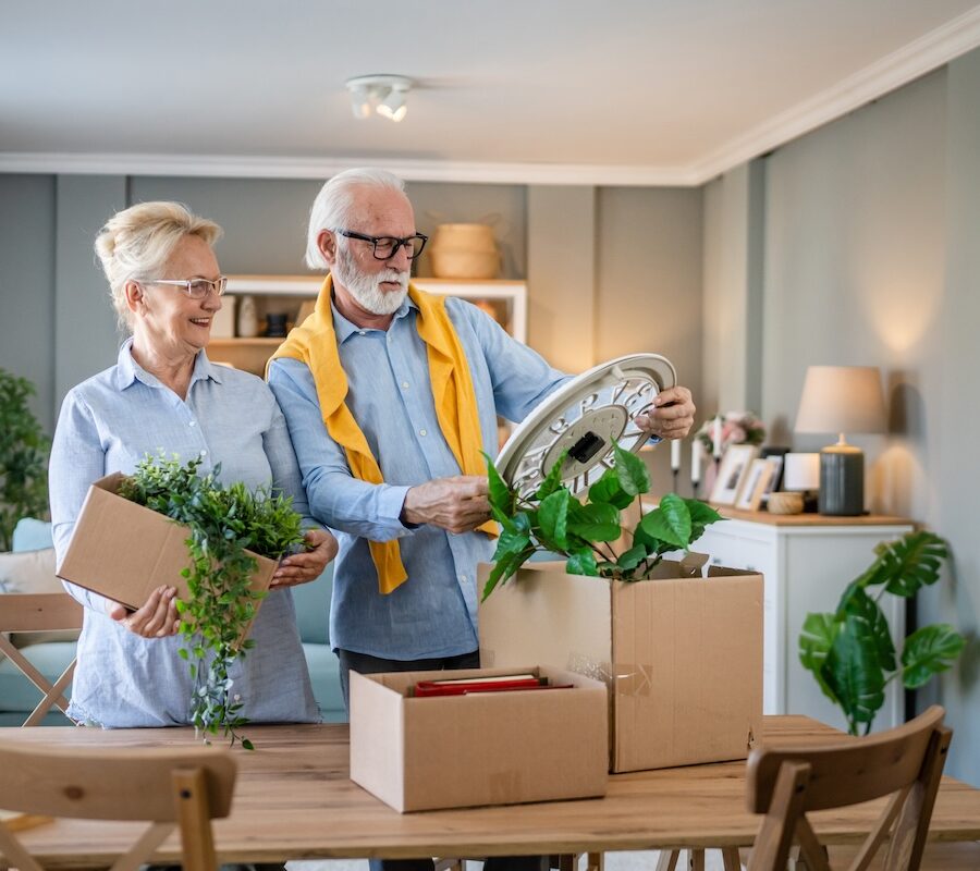 A senior couple unpack moving boxes