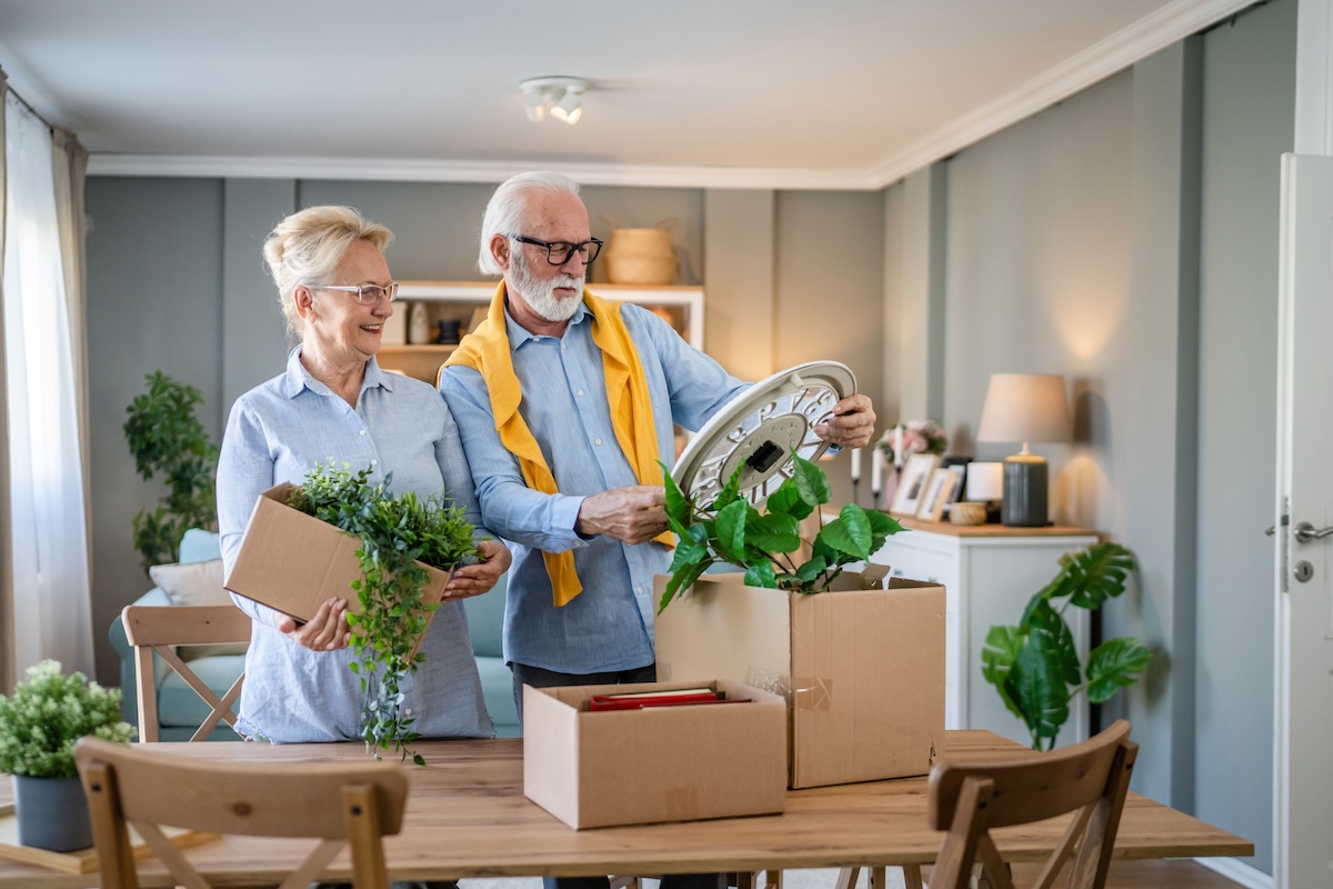 A senior couple unpack moving boxes