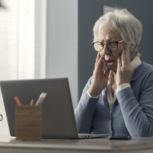 Senior woman looking confused on computer | Protecting seniors from scams