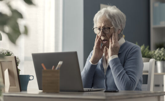 Senior woman looking confused on computer | Protecting seniors from scams