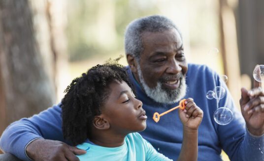 Child blowing bubbles with grandparent | Things to do with grandkids in St. Louis