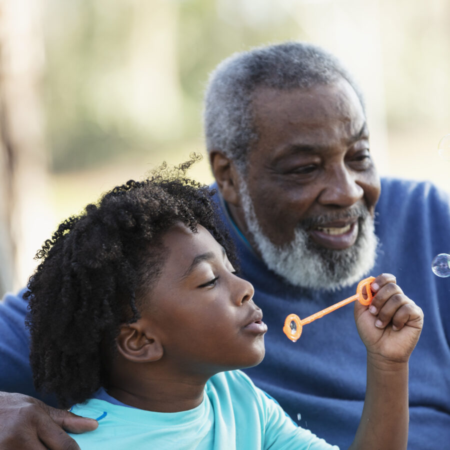 Child blowing bubbles with grandparent | Things to do with grandkids in St. Louis