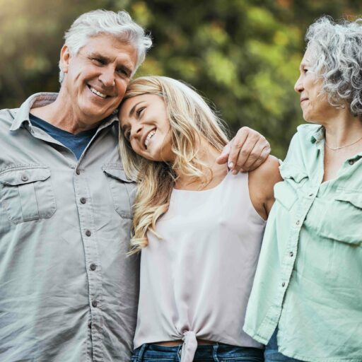 Loving family embracing senior parents, overcoming fear of change by considering St. Louis independent senior living community. Happy elderly couple bonding with daughter, smiling with care and love on weekend in USA.