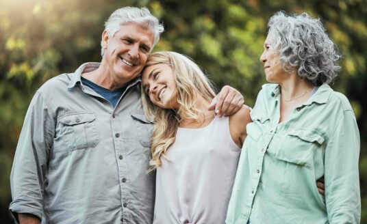 Loving family embracing senior parents, overcoming fear of change by considering St. Louis independent senior living community. Happy elderly couple bonding with daughter, smiling with care and love on weekend in USA.