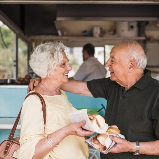 Senior couple eating at food truck during St. Louis summer events