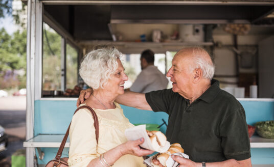 Senior couple eating at food truck during St. Louis summer events