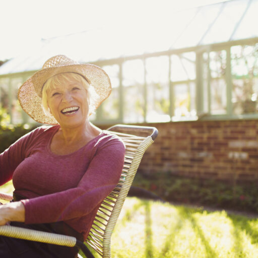 Senior woman outside by greenhouse | Summer heat safety tips for seniors