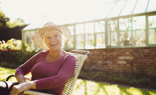 Senior woman outside by greenhouse | Summer heat safety tips for seniors