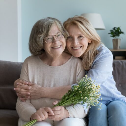 Happy cute elder mom and mature daughter woman hugging with love, care, tenderness, joy