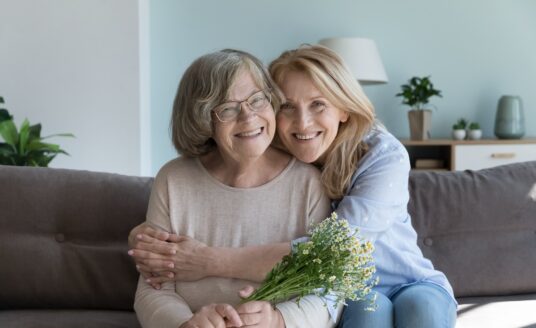 Happy cute elder mom and mature daughter woman hugging with love, care, tenderness, joy