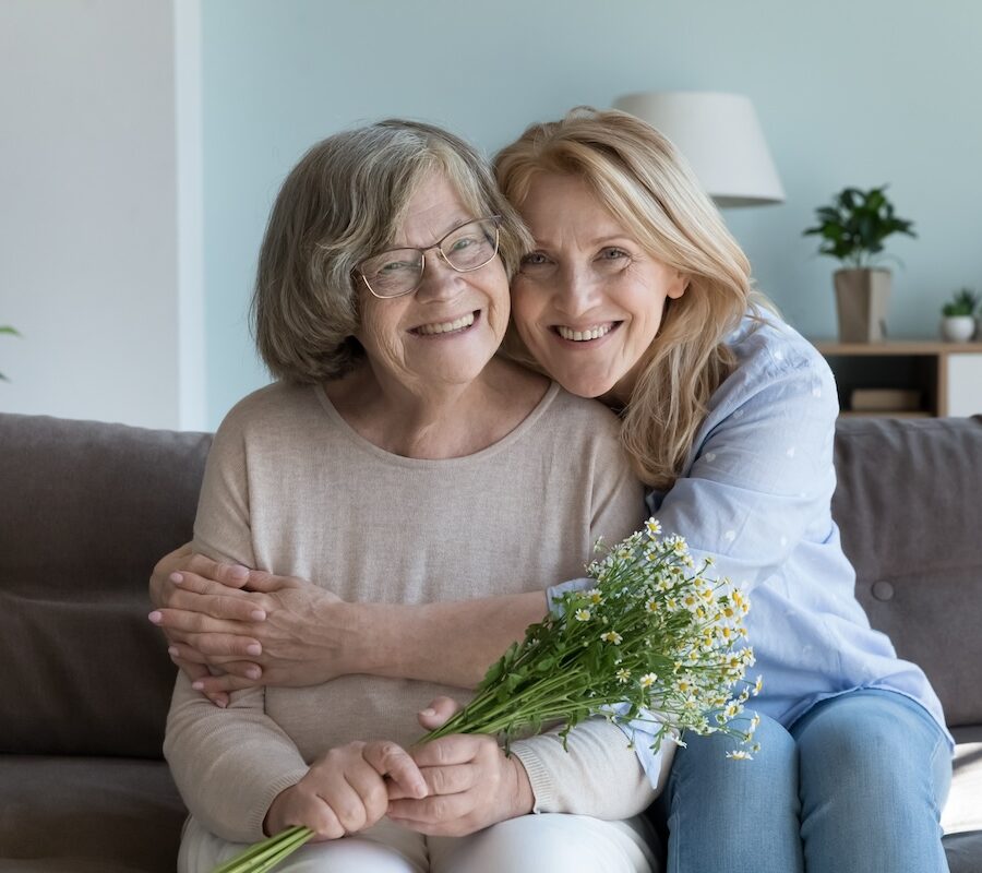 Happy cute elder mom and mature daughter woman hugging with love, care, tenderness, joy