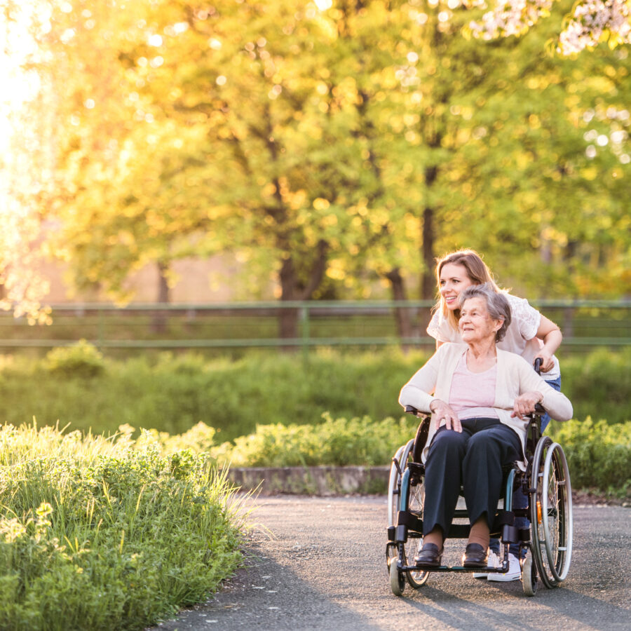 Young woman walking with senior woman in park | Explore St. Louis accessible parks near you