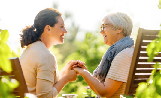 Woman asking grandmother questions for reminiscing with seniors