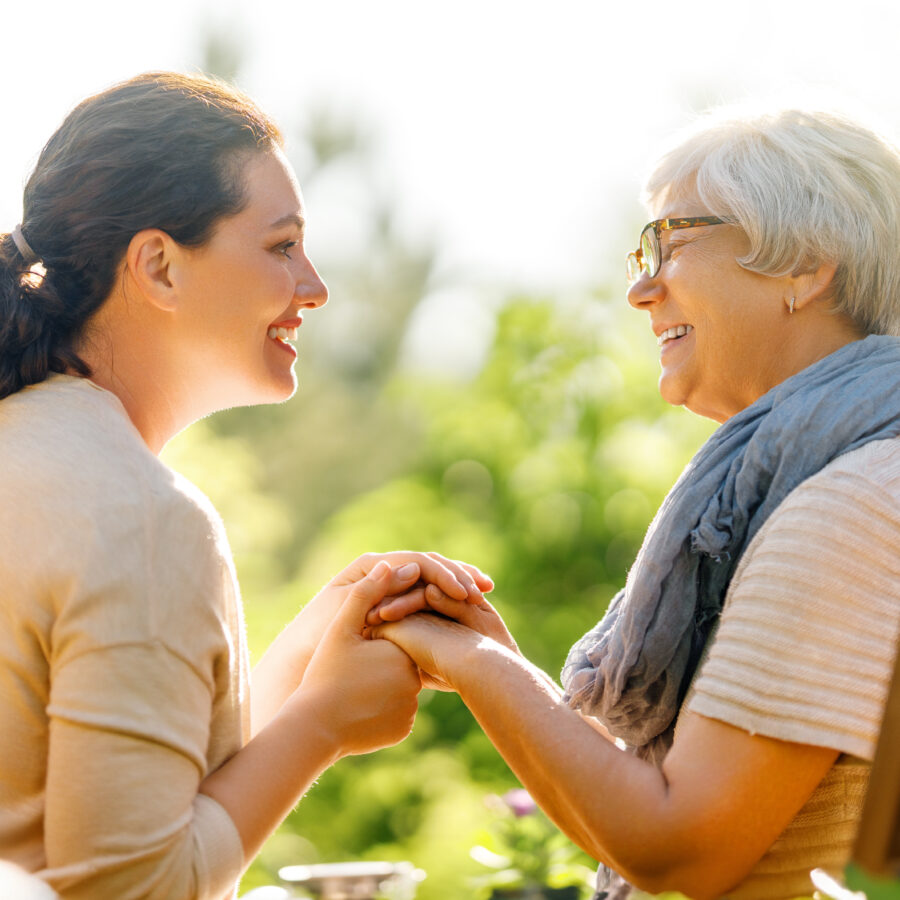 Woman asking grandmother questions for reminiscing with seniors