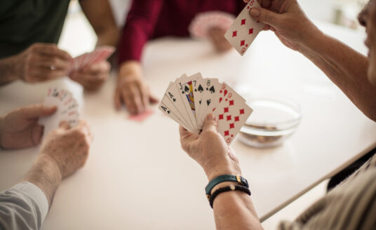 Group of seniors playing card games for seniors