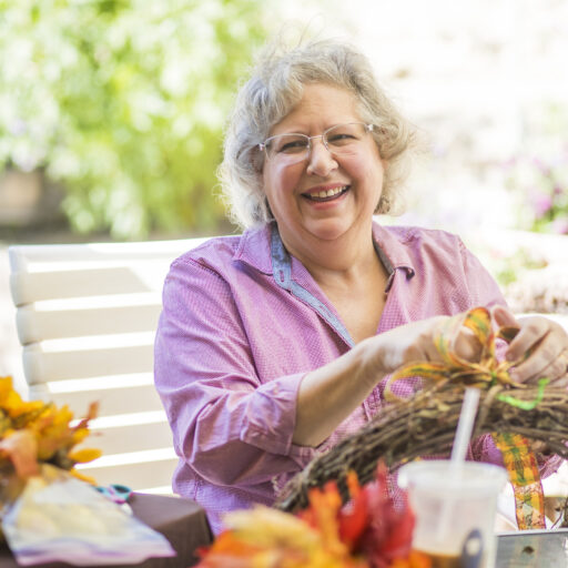 Elderly woman making Thanksgiving crafts for seniors