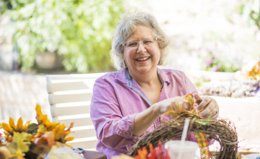 Elderly woman making Thanksgiving crafts for seniors