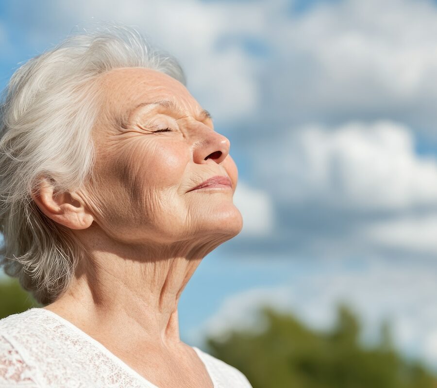 senior woman taking a breath on a sunny day, mental health