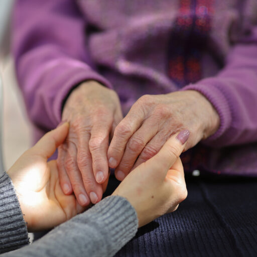 Woman comforting someone on hospice