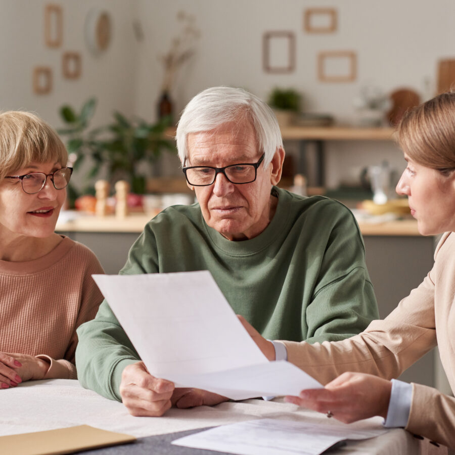 Senior couple getting their affairs in order by discussing legal paperwork