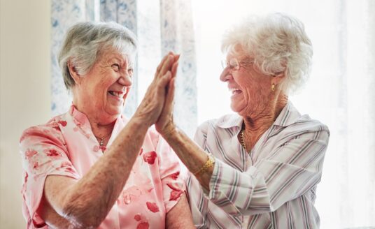 Happy, love and senior women with a high five for care