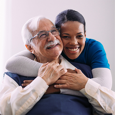 Hospice caregiver hugs older man