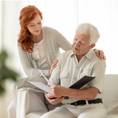 Volunteer assists older male hospice patient