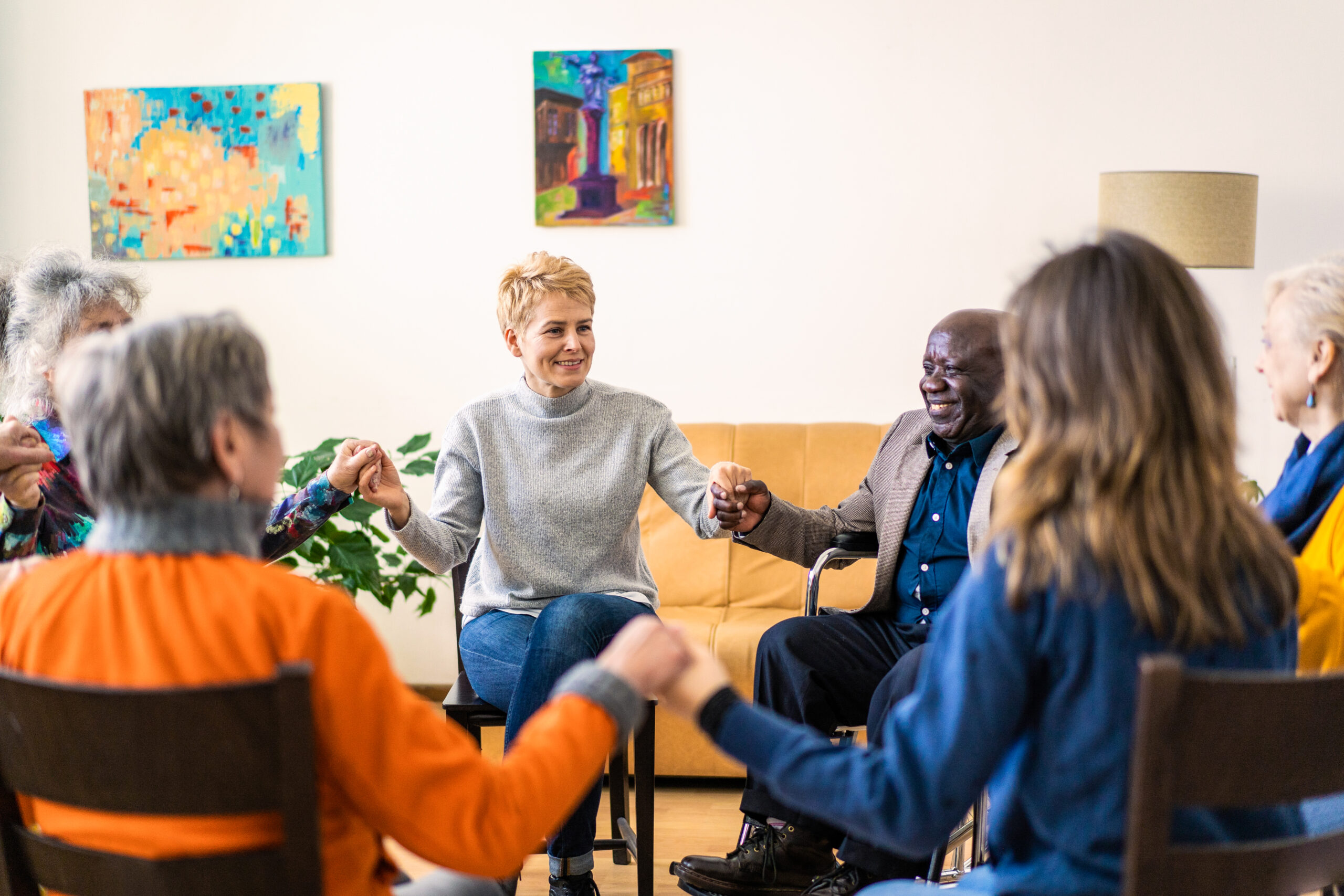 Grief support group holding hands in a circle