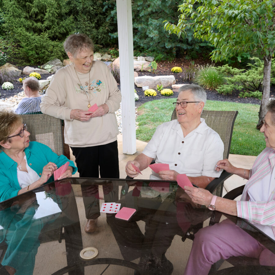 Bethesda Terrace residents playing cards under the gazebo